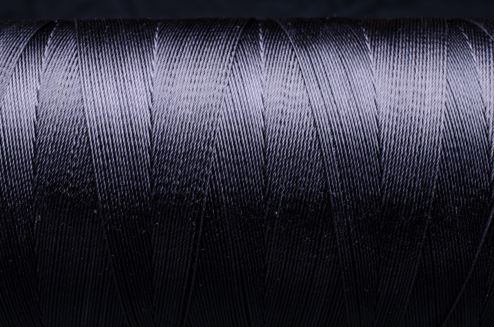 Textured metallic thread embroidery on dark fabric
